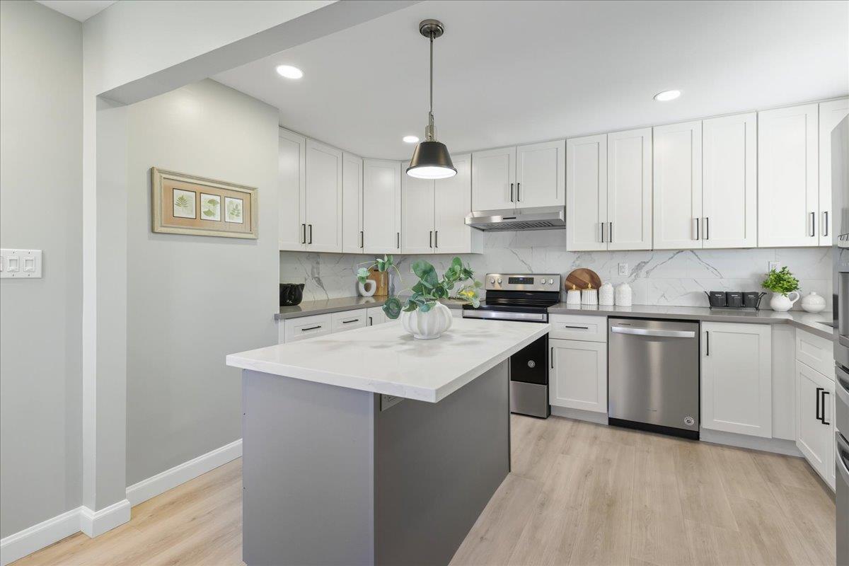 18 Culver Court San Mateo, CA 94403 - Photo 17 of 71 a kitchen with stainless steel appliances granite countertop a sink stove and white cabinets