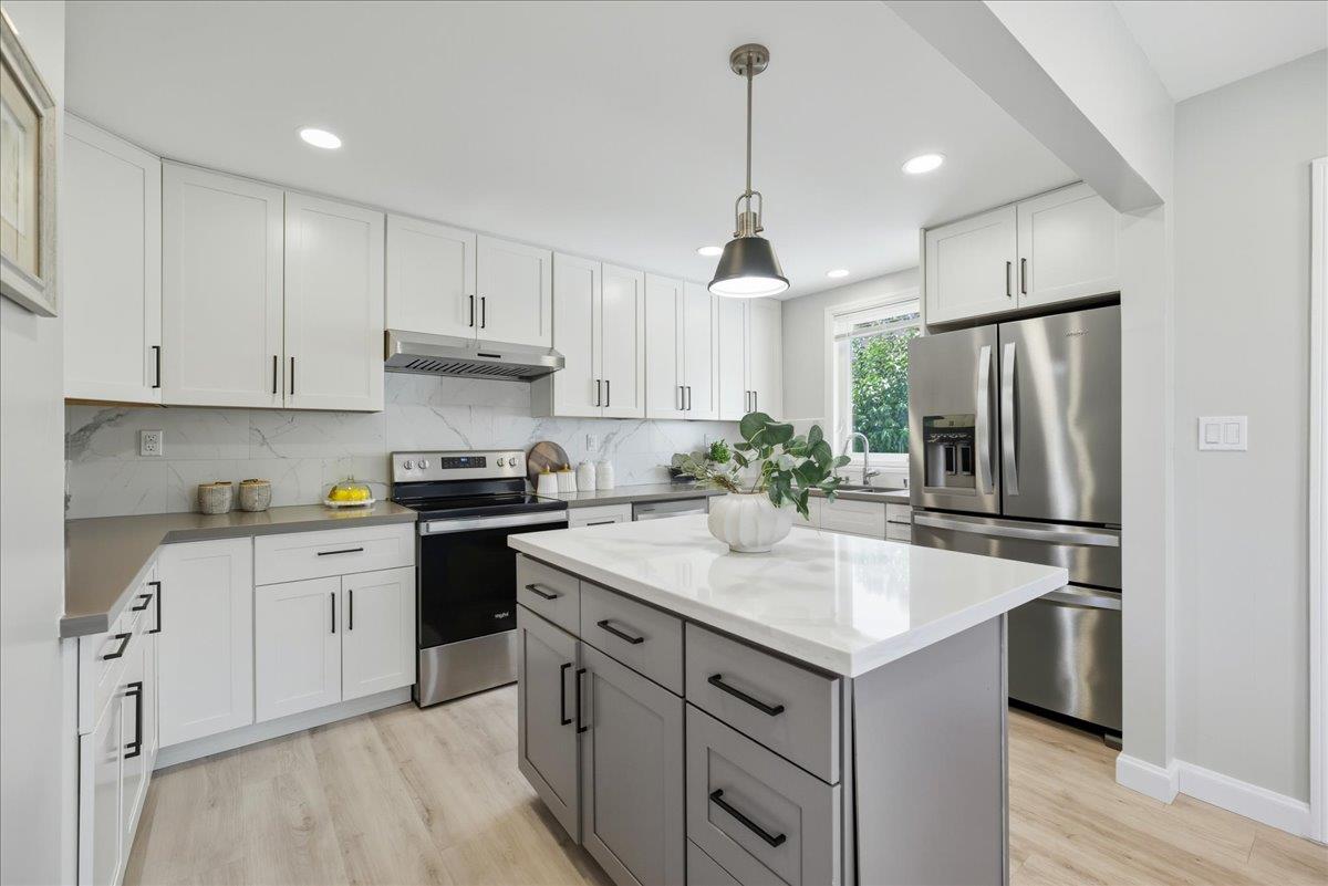18 Culver Court San Mateo, CA 94403 - Photo 18 of 71 a kitchen with a sink refrigerator and cabinets