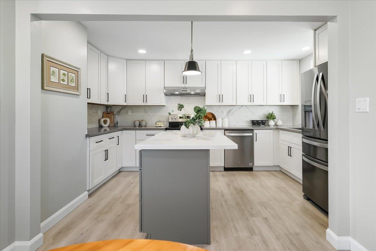 18 Culver Court San Mateo, CA 94403 - Photo 23 of 71 a kitchen with white cabinets and white appliances
