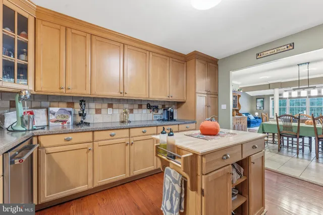 a kitchen with granite countertop a sink stove and cabinets