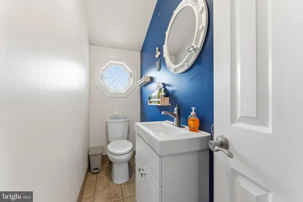 a bathroom with a toilet a sink and mirror