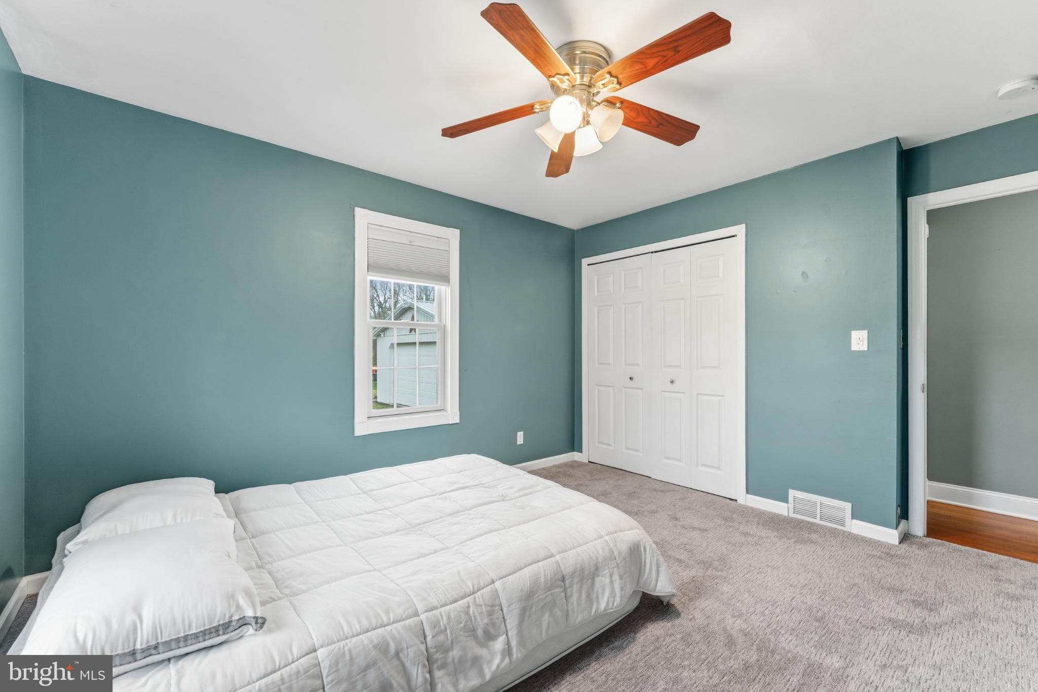 332 Gordon Road Robbinsville, NJ 08691 - Photo 22 of 47 a bedroom with a large bed and a chandelier