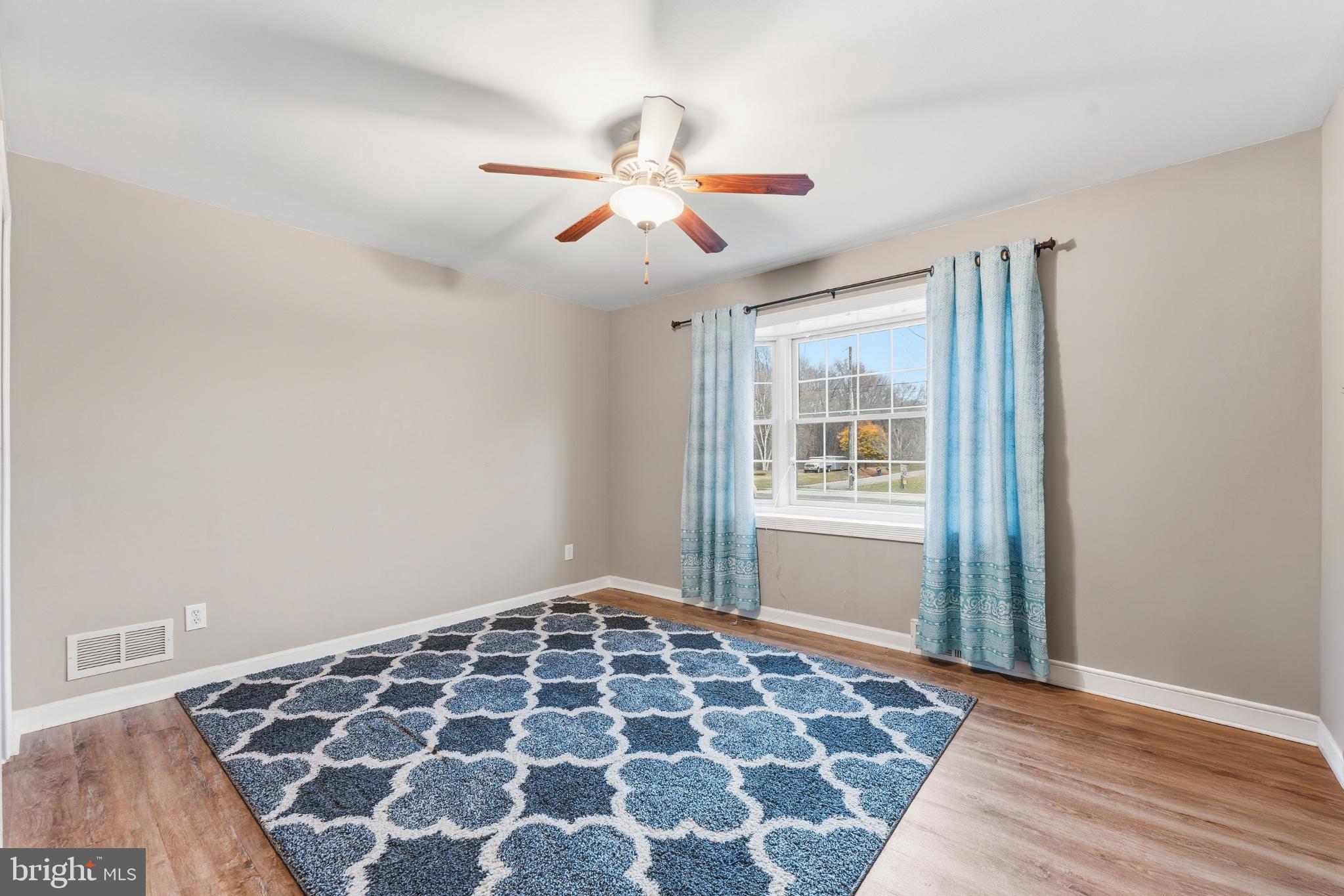 332 Gordon Road Robbinsville, NJ 08691 - Photo 25 of 47 a view of an empty room with wooden floor and a window