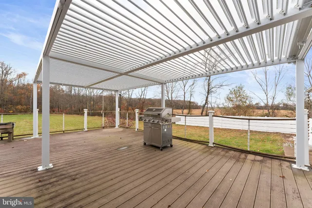 a view of a room with wooden floor and iron stairs