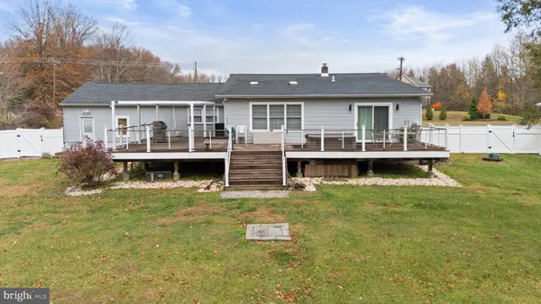 a front view of house with yard and swimming pool