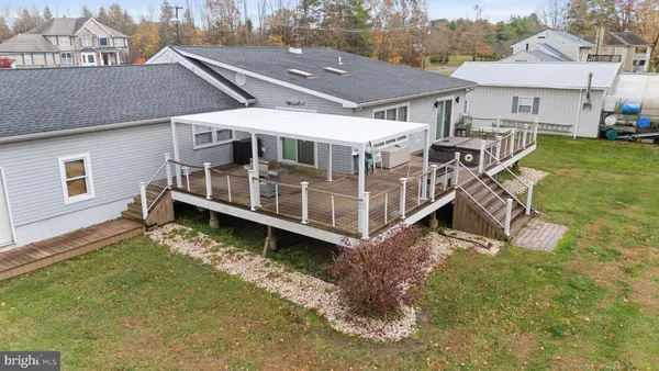 an aerial view of a house with a yard