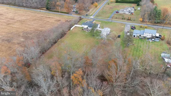 a view of a field with trees and a covered with wooden fence