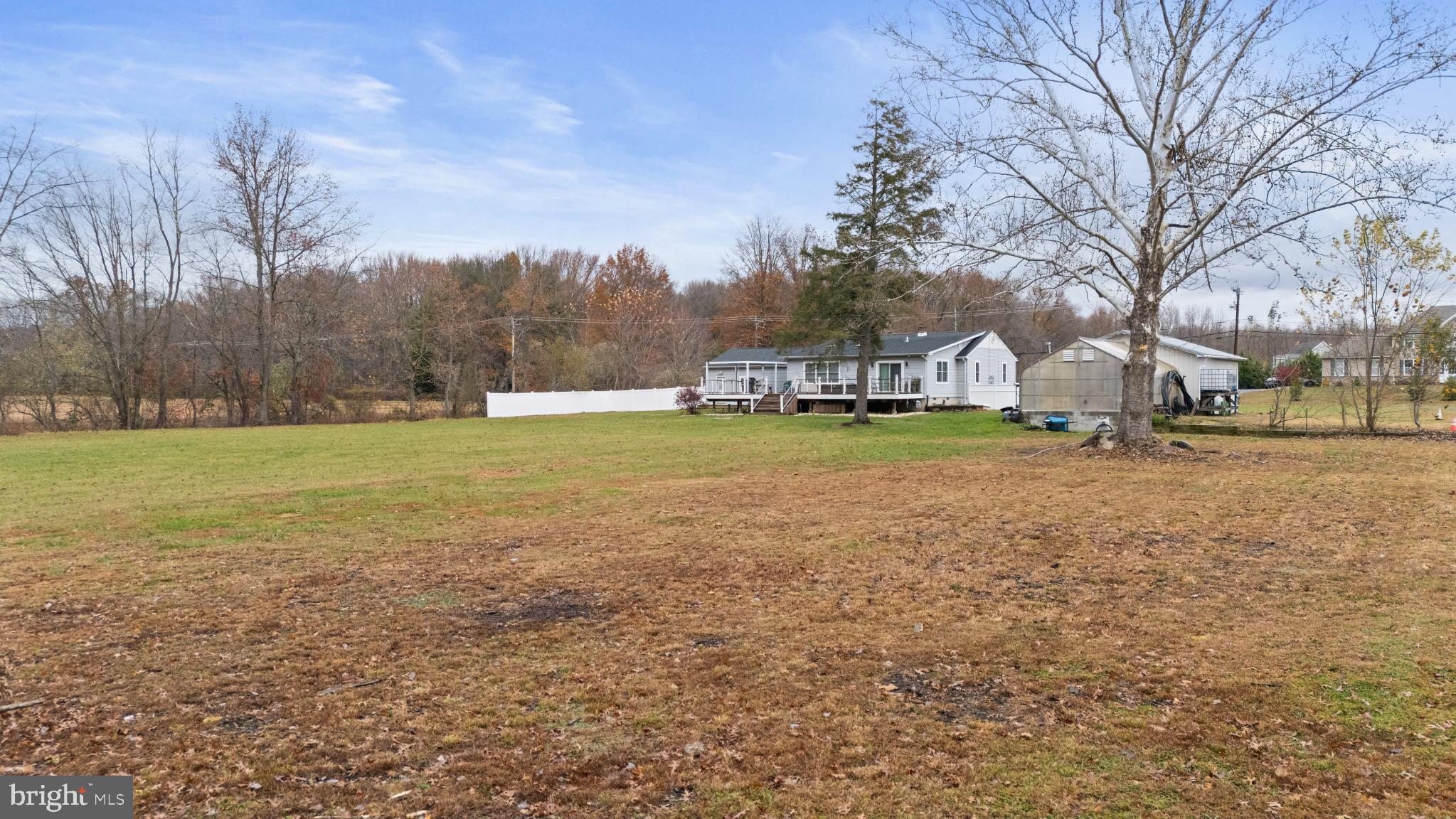 332 Gordon Road Robbinsville, NJ 08691 - Photo 46 of 47 a view of a field with trees and a covered with wooden fence