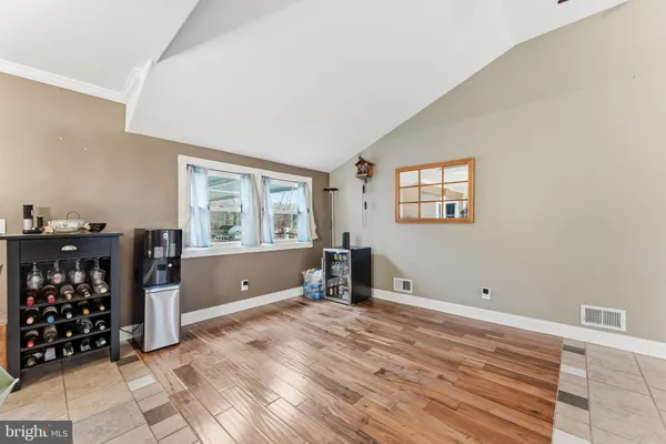 a view of a room with wooden floor and windows