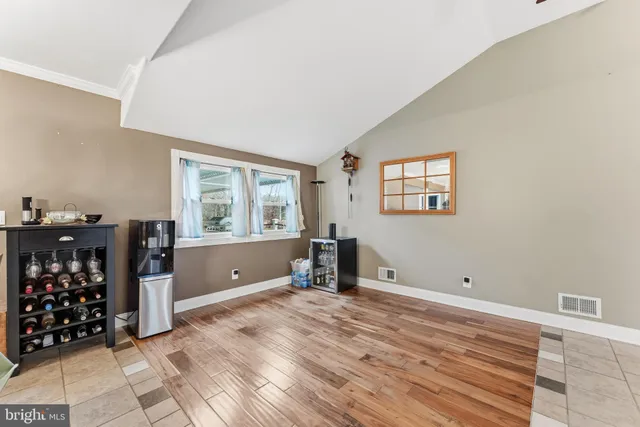 a view of a room with wooden floor and windows