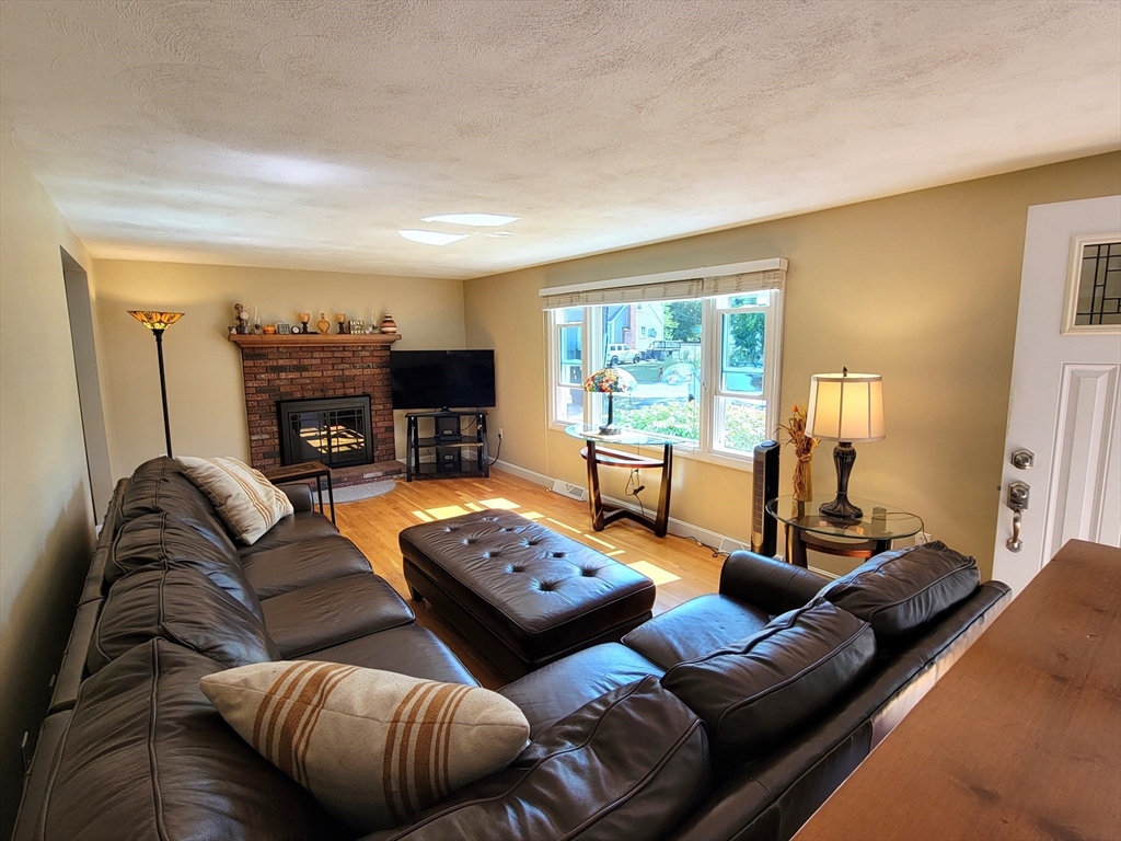 75 Brown Street Tewksbury, MA 01876 - Photo 11 of 28 a living room with furniture fireplace and a large window