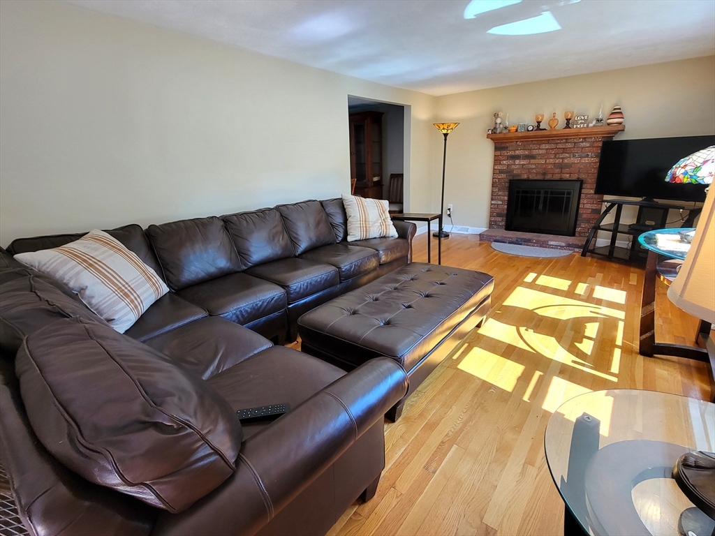 75 Brown Street Tewksbury, MA 01876 - Photo 12 of 28 a living room with furniture and a fireplace