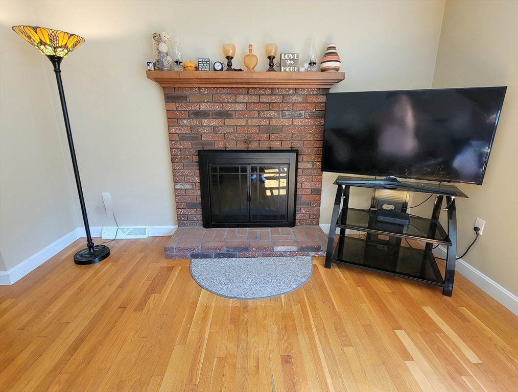 75 Brown Street Tewksbury, MA 01876 - Photo 13 of 28 a living room with furniture and a fireplace