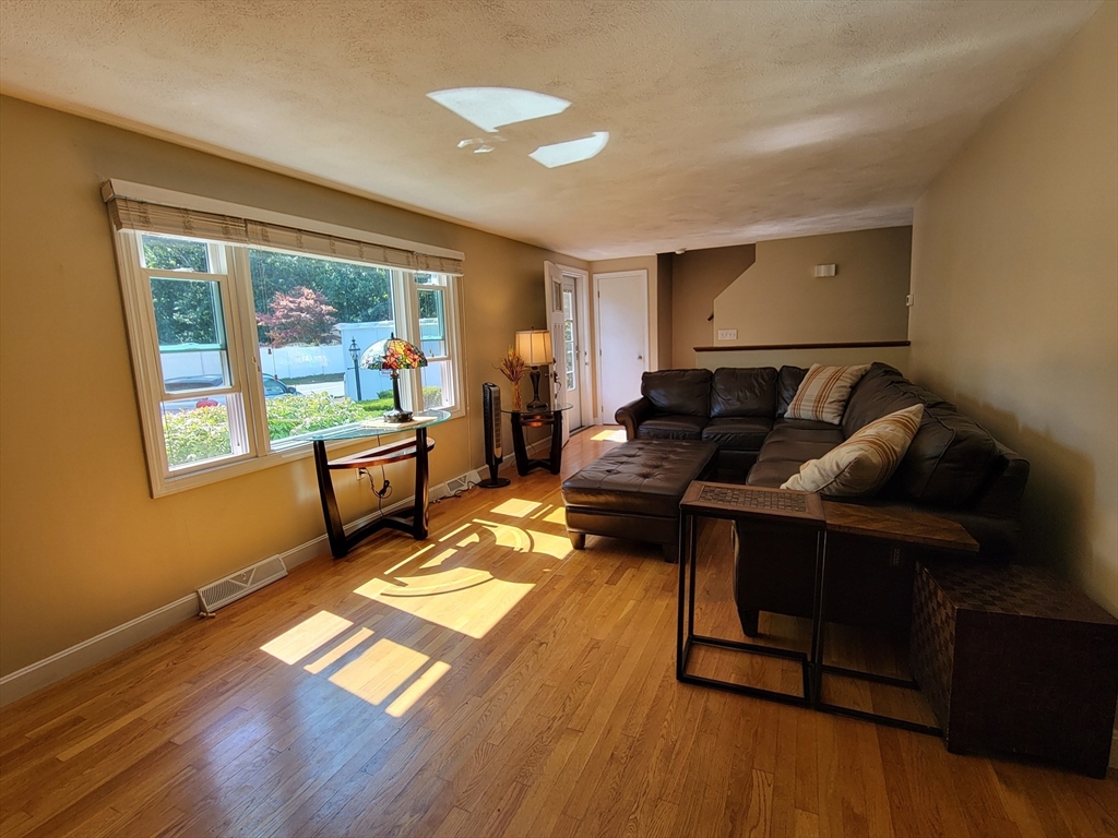 75 Brown Street Tewksbury, MA 01876 - Photo 14 of 28 a living room with furniture and a gate