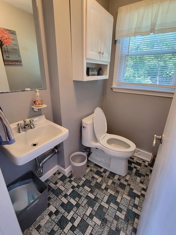 75 Brown Street Tewksbury, MA 01876 - Photo 5 of 28 a bathroom with a sink toilet and a window