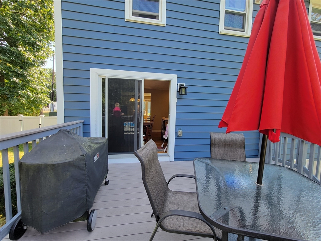 75 Brown Street Tewksbury, MA 01876 - Photo 9 of 28 a view of a patio with a dining table and chairs