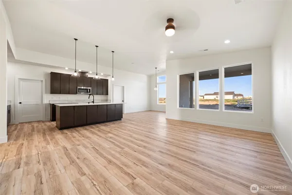 an empty room with closet and windows