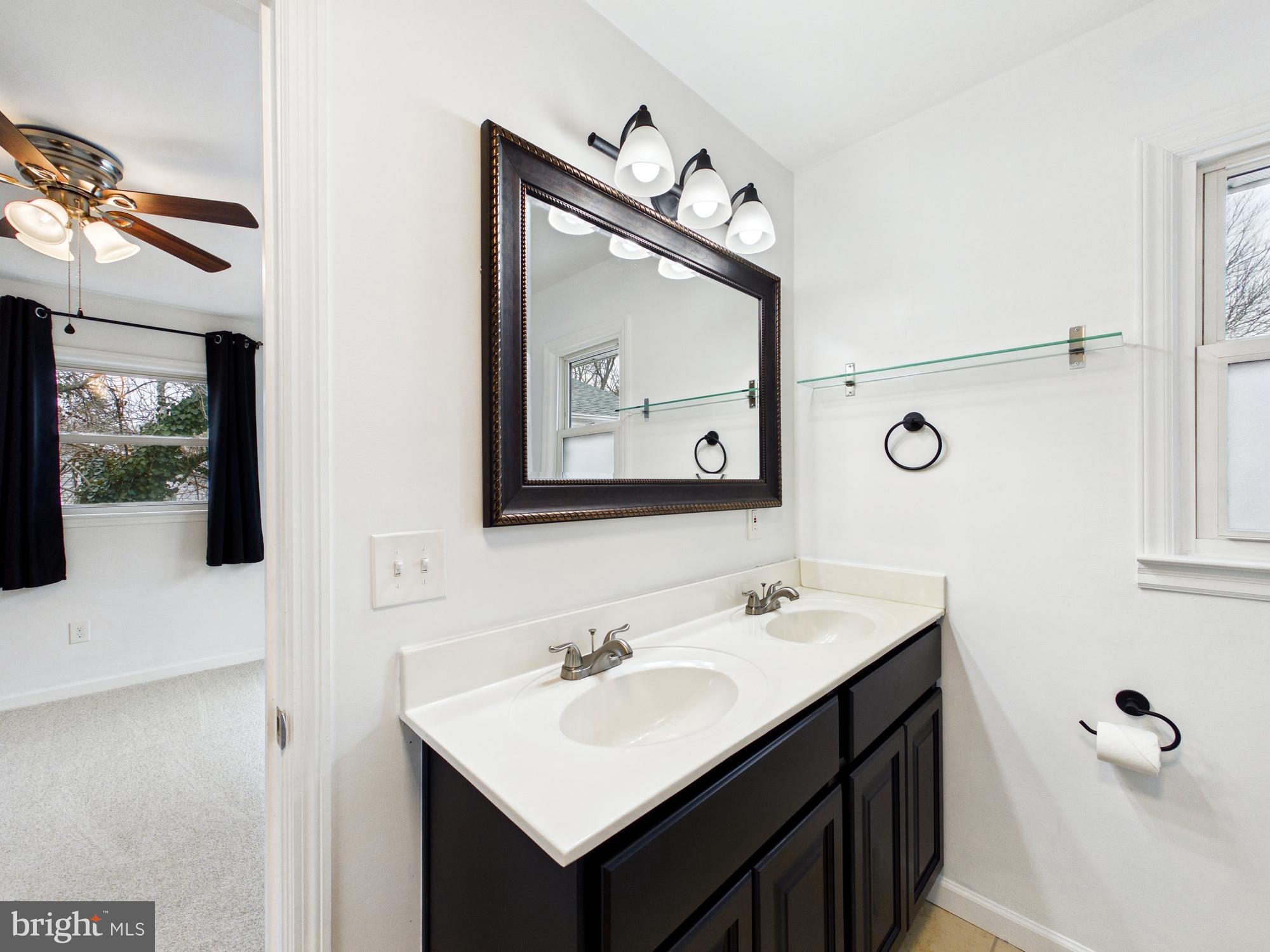 3231 Williamsville Road Houston, DE 19954 - Photo 24 of 64 Elegant dual vanity in primary bathroom.