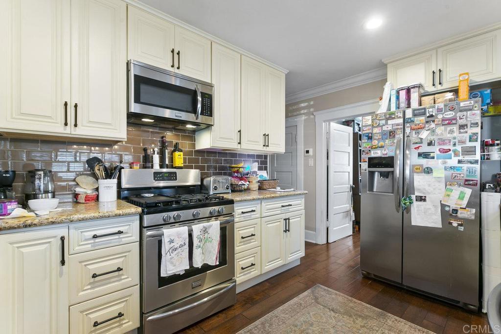 3373-3379 1/2 Herman Avenue San Diego, CA 92104 - Photo 15 of 70 a kitchen with stainless steel appliances granite countertop a refrigerator stove and sink
