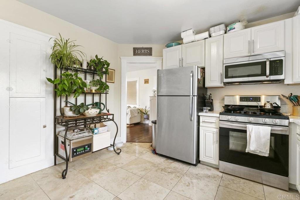 3373-3379 1/2 Herman Avenue San Diego, CA 92104 - Photo 28 of 70 a kitchen with a refrigerator a stove a microwave and cabinets