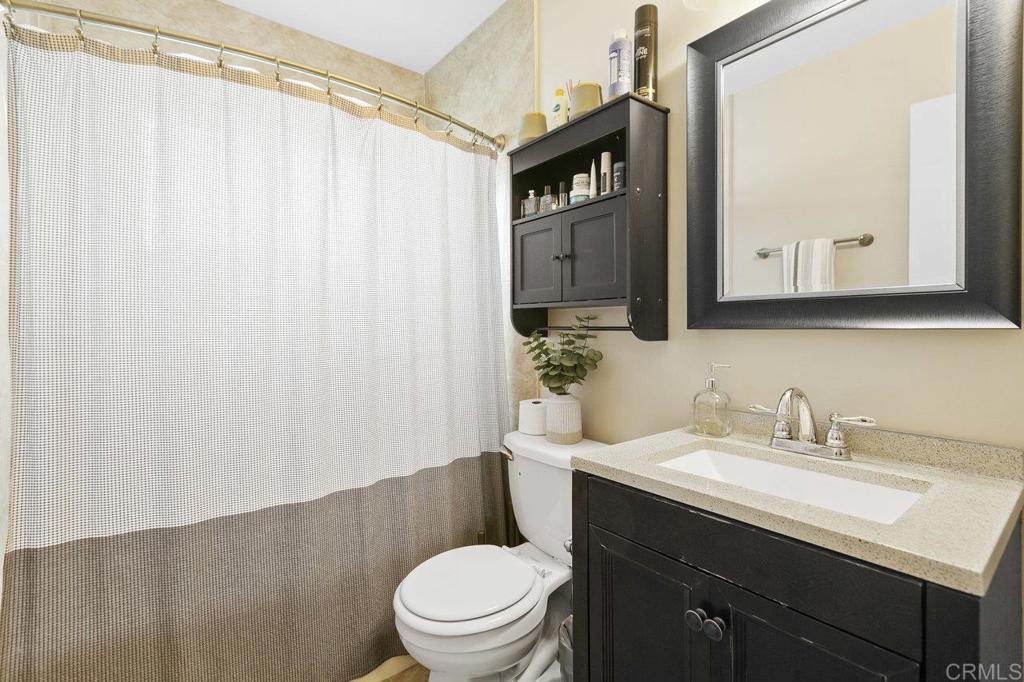 3373-3379 1/2 Herman Avenue San Diego, CA 92104 - Photo 38 of 70 a bathroom with a sink a toilet and shower curtain