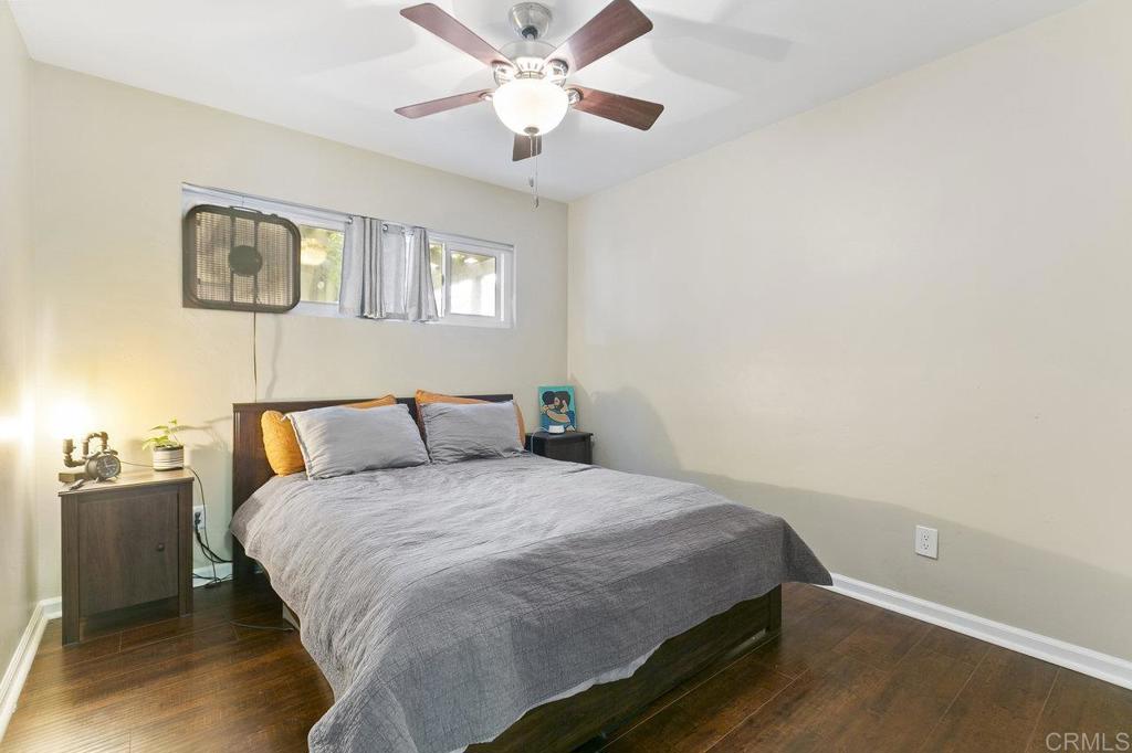 3373-3379 1/2 Herman Avenue San Diego, CA 92104 - Photo 47 of 70 a bedroom with a large bed and a chandelier