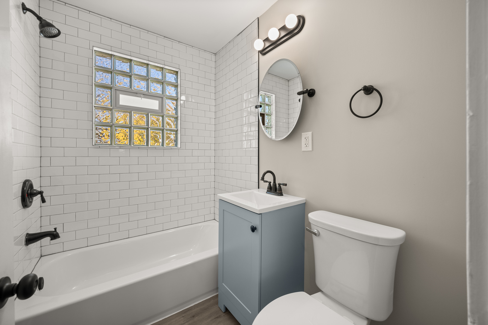 321 North Locust Street Sycamore, IL 60178 - Photo 11 of 38 a bathroom with a toilet a sink and mirror