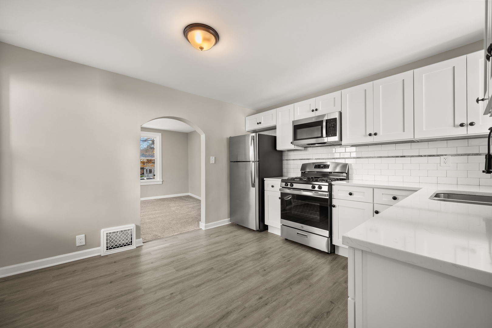 321 North Locust Street Sycamore, IL 60178 - Photo 10 of 38 a kitchen with granite countertop a refrigerator stove and microwave
