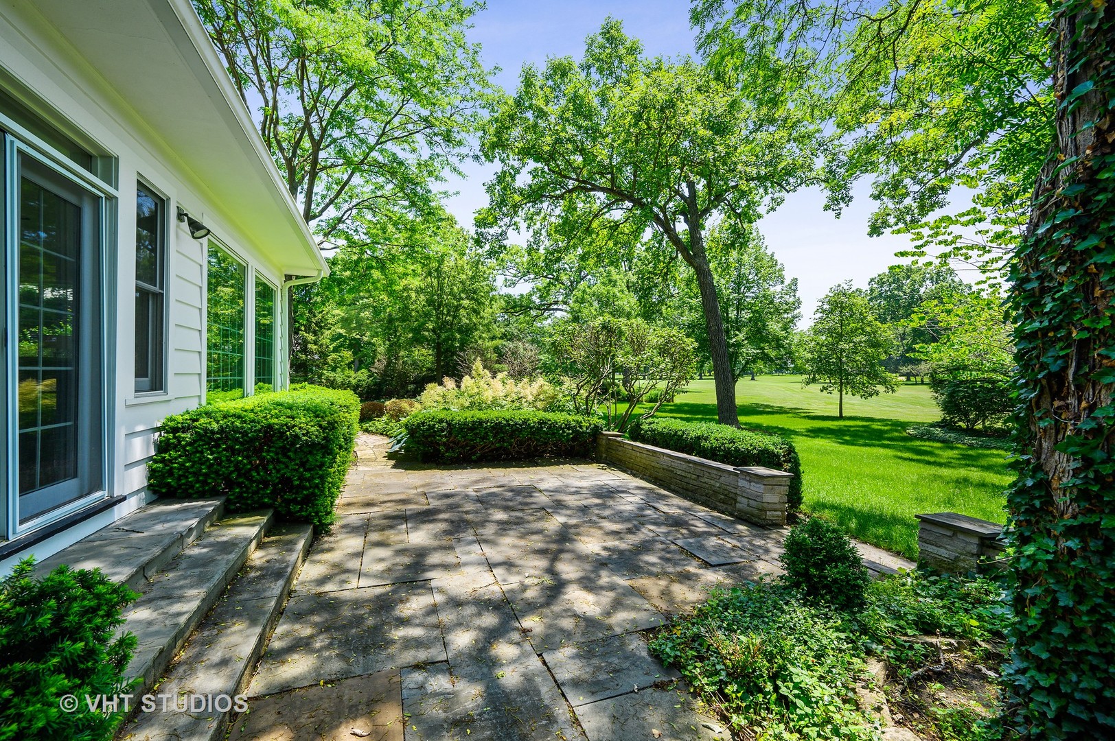 44 Indian Hill Road Winnetka, IL 60093 - Photo 19 of 49 a view of a garden with a bench in garden