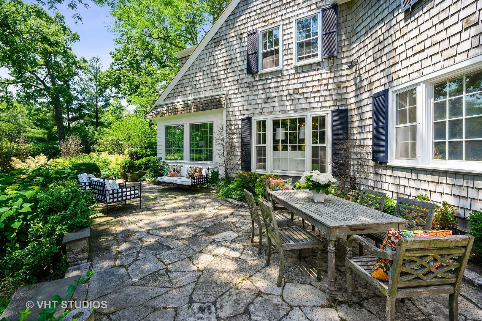 44 Indian Hill Road Winnetka, IL 60093 - Photo 20 of 49 a view of backyard with table and chairs and potted plants