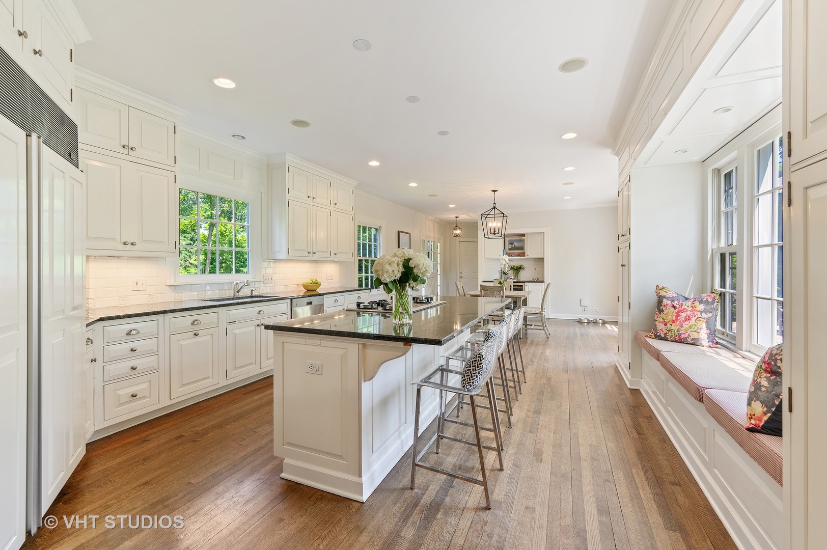 44 Indian Hill Road Winnetka, IL 60093 - Photo 24 of 49 a kitchen with counter top space a sink wooden floor and stainless steel appliances