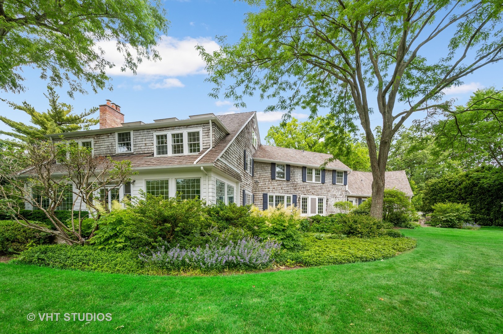 44 Indian Hill Road Winnetka, IL 60093 - Photo 49 of 49 a front view of a house with a garden