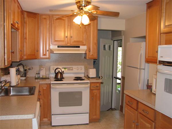 88 Woodrow Street Springfield, MA 01119 - Photo 2 of 4 a kitchen with stainless steel appliances granite countertop a sink a stove and a refrigerator