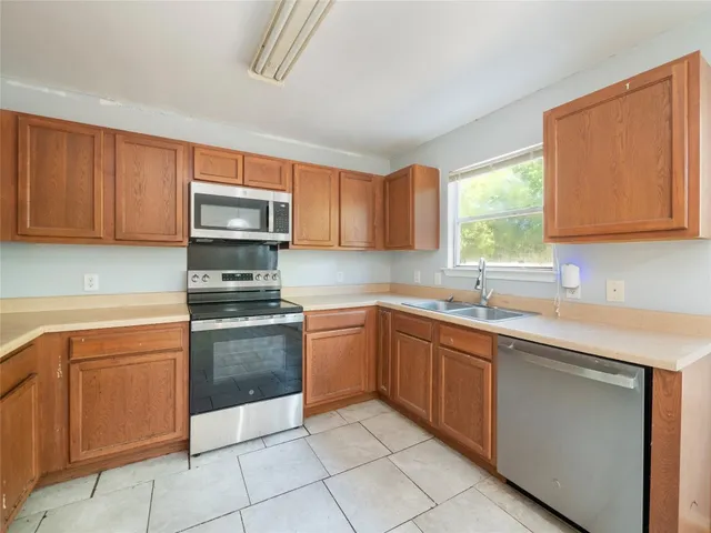 a kitchen with stainless steel appliances granite countertop a sink and cabinets