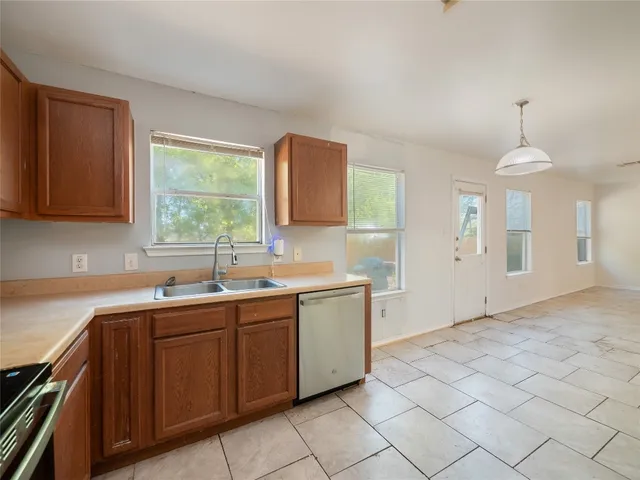 a kitchen with a sink cabinets and window