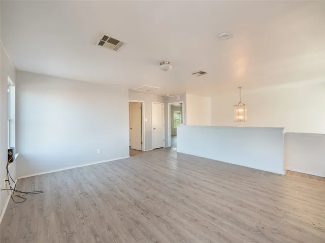 a view of a kitchen with wooden floor and a sink