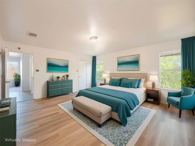 a spacious bedroom with a bed and a couch