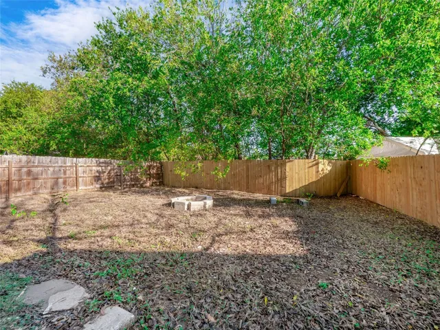 a backyard of a house with a trees
