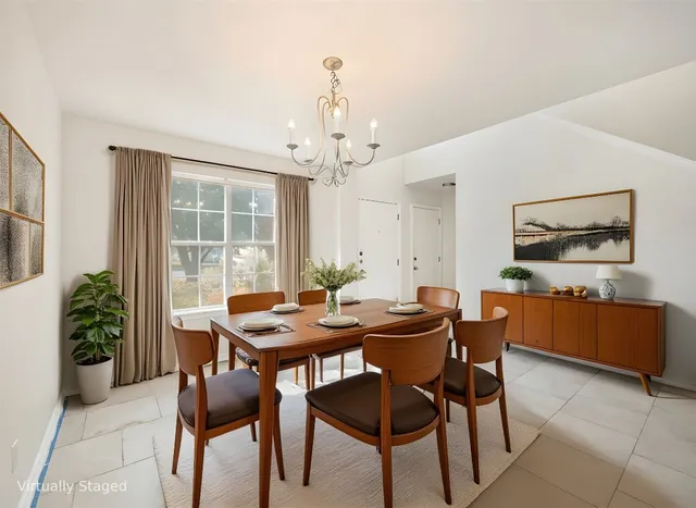 a view of a dining room with furniture and window