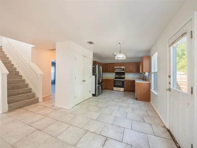 a view of a kitchen with furniture and windows