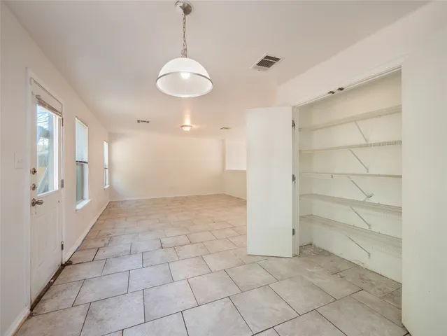 a view of a room with a windows and ceiling fan