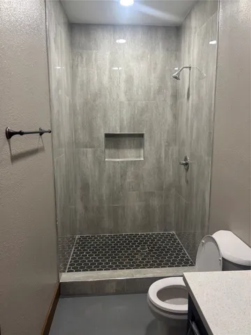 a bathroom with a sink toilet and shower