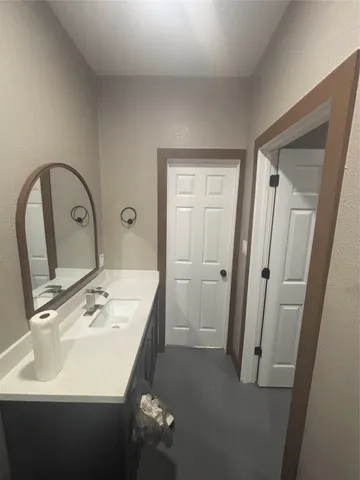 a bathroom with a sink and mirror with toilet