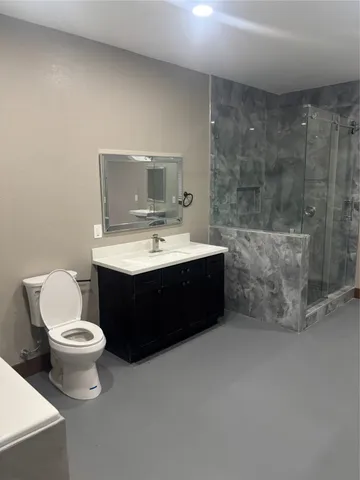 a bathroom with a sink toilet and mirror