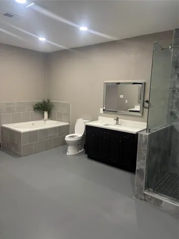 a bathroom with a double vanity sink and a bathtub