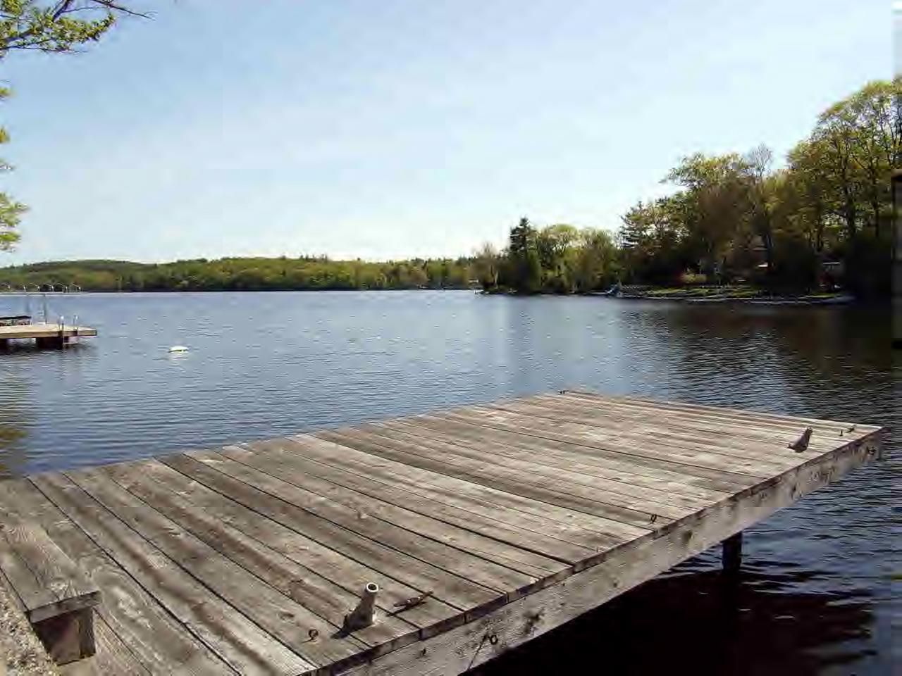 164 Kibbe Road Otis, MA 01029 - Photo 3 of 3 a view of a lake with houses in the back