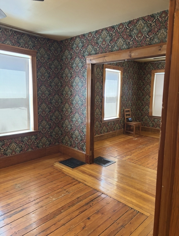 13 Moulton Street Lynn, MA 01905 - Photo 3 of 18 a view of a room with wooden floor and a window