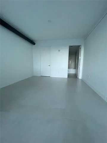 a bathroom with a granite countertop sink a toilet a large mirror and bathtub