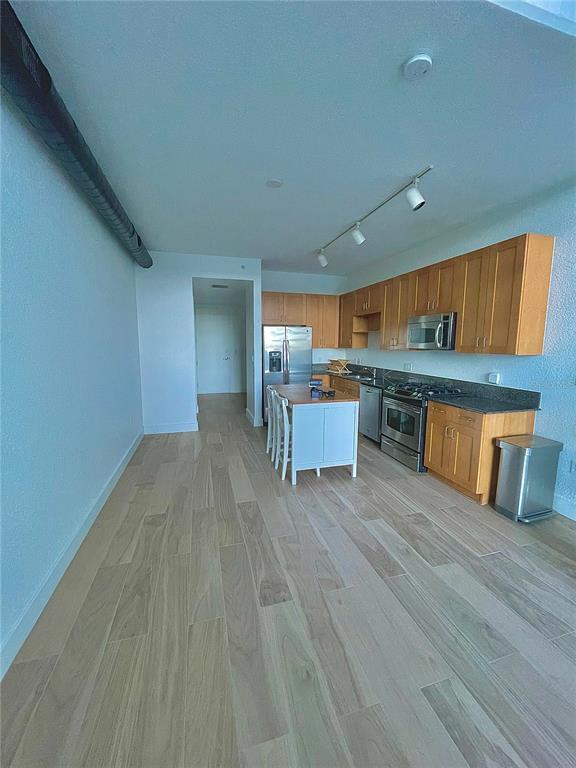 150 East Robinson Street, Unit 2A6 Orlando, FL 32801 - Photo 9 of 33 a room with wooden floor and furniture