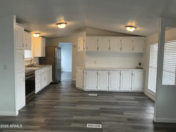 a kitchen with cabinets wooden floor and a sink